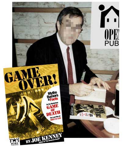 Joe Kenney, author of GAME OVER!, signing his book. Joe asked me to have his face covered to hide his identity.