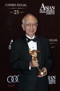 Veteran Hong Kong producer Raymond Chow poses with the trophy after winning the Lifetime Achievement award at the Asian Film Awards in Hong Kong