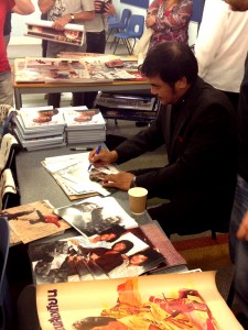 Hwang Jang Lee signing memorabilia for fans.